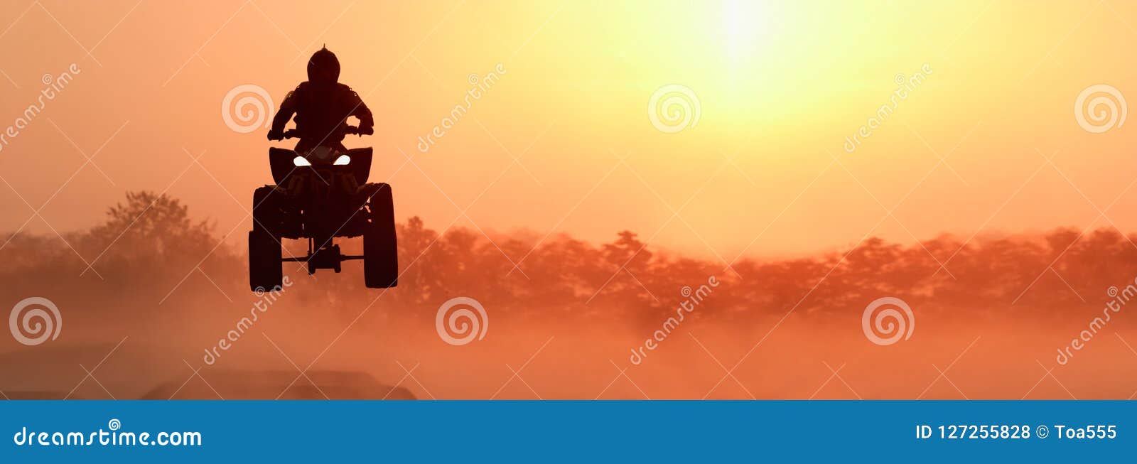 silhouette atv or quad bikes jump in sunset.