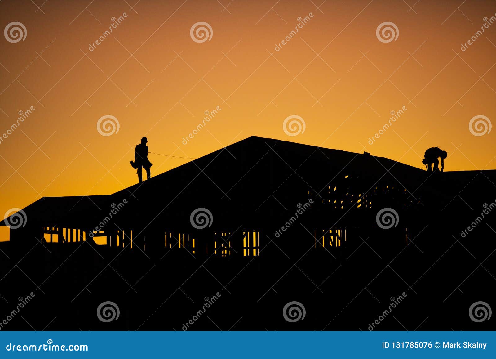 silhouette of builders during sunset