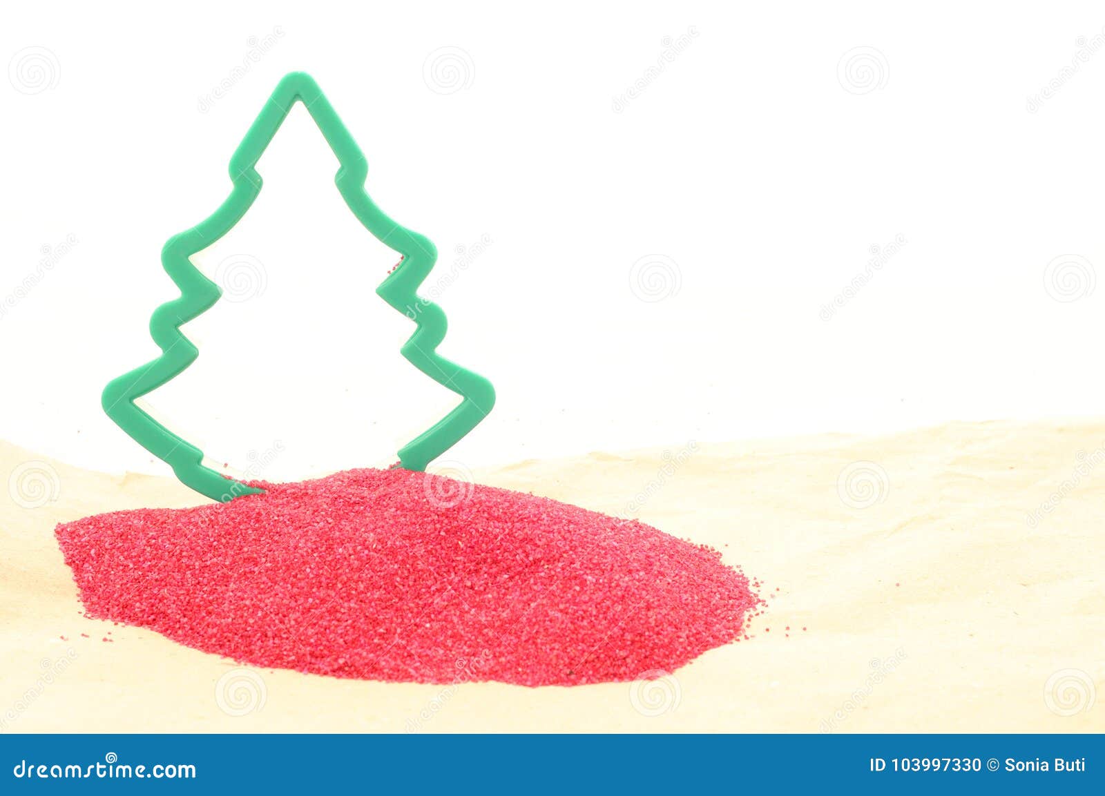 Silhouette of a Christmas tree on a pile of purplish red