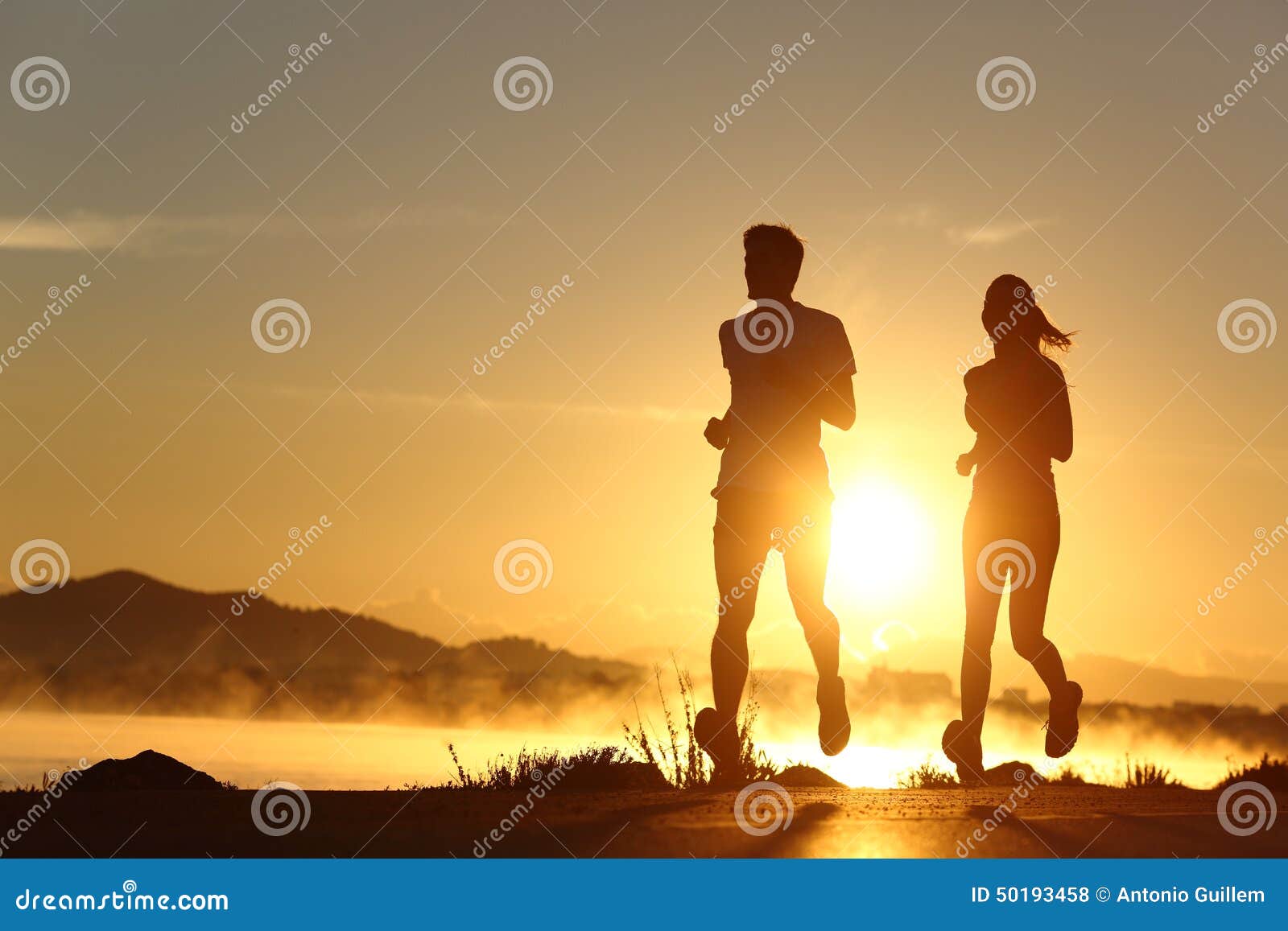 silhouette of a couple running at sunset