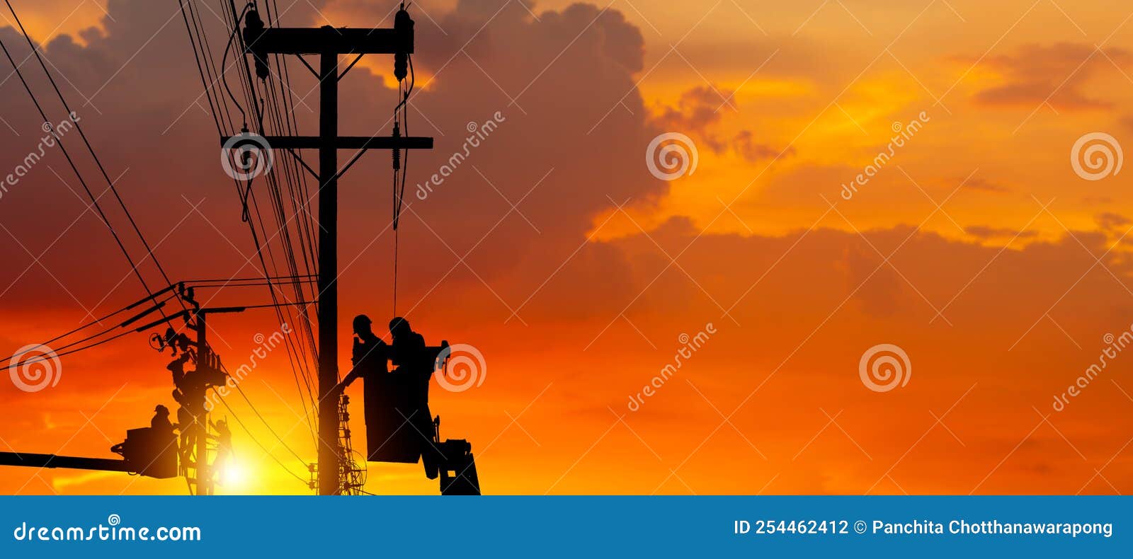 Silhouette of Electrician Officer Climbs a Pole and Uses a Cable