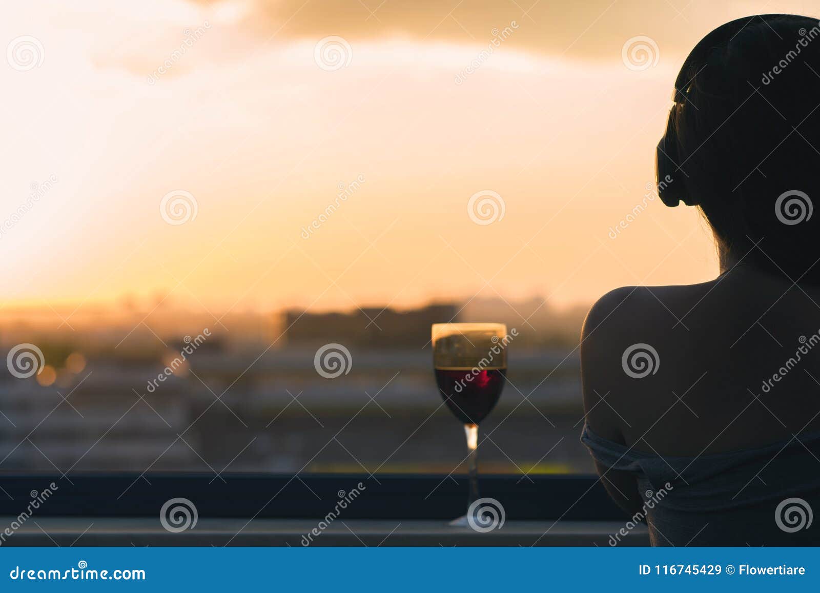 Silhouette of Female Hand with Glass of Red Wine on the Sunset Town ...