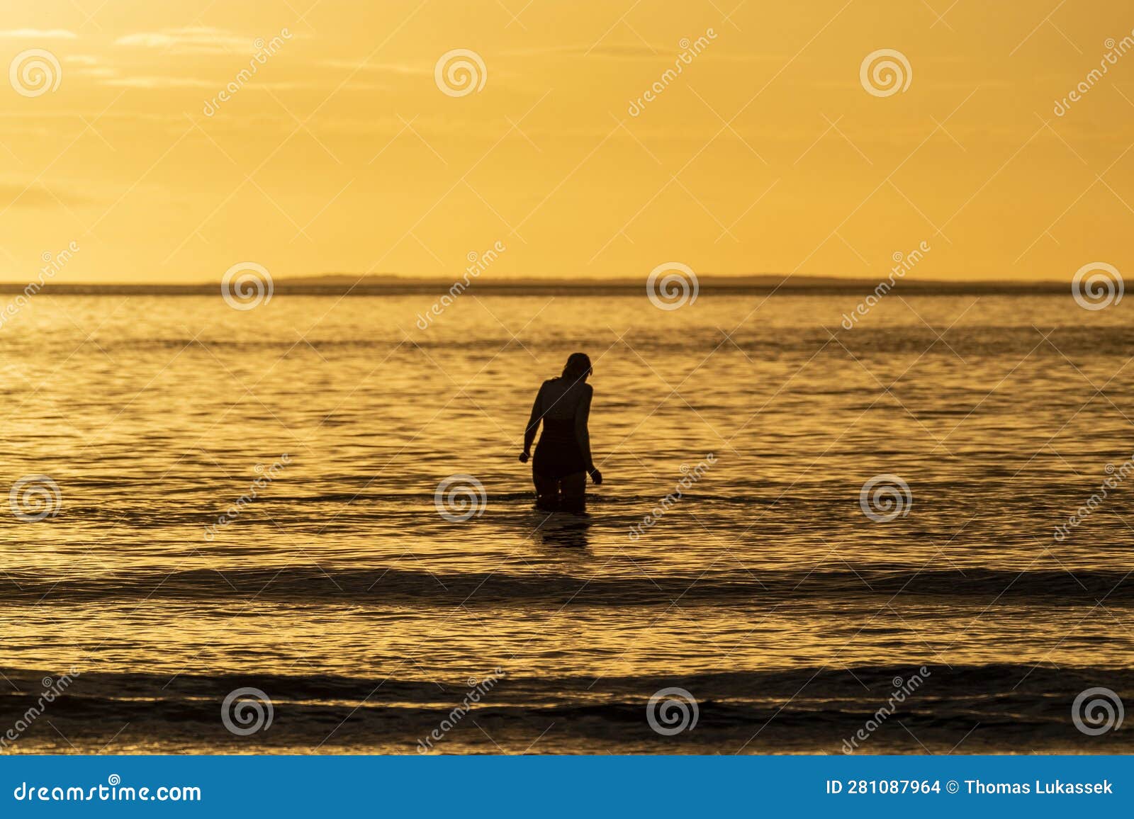 Silhouette of Female Swimmer Going into the Atlantic Ocean in Ireland Silhouette of Female Swimmer Going into the Atlantic Ocean in Ireland