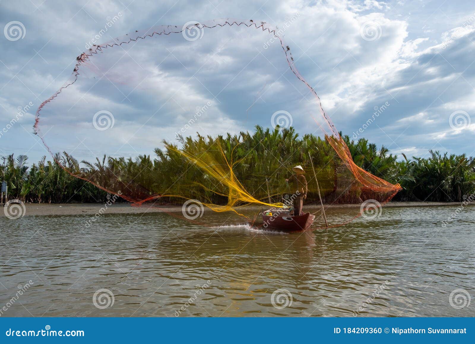 Silhouette of Fisherman Casting Fishing Net into the River