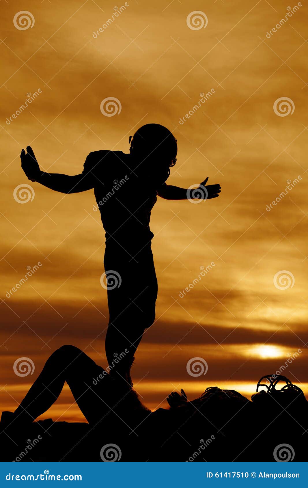 Silhouette of a Football Player after a Tackle Stock Photo - Image