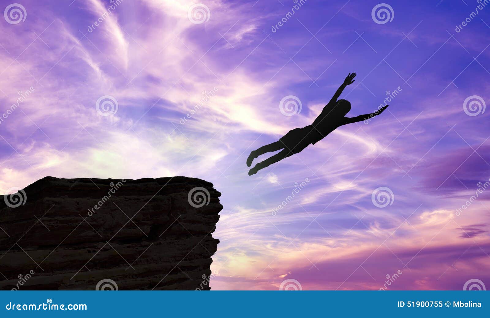 silhouette of a man jumping off a cliff