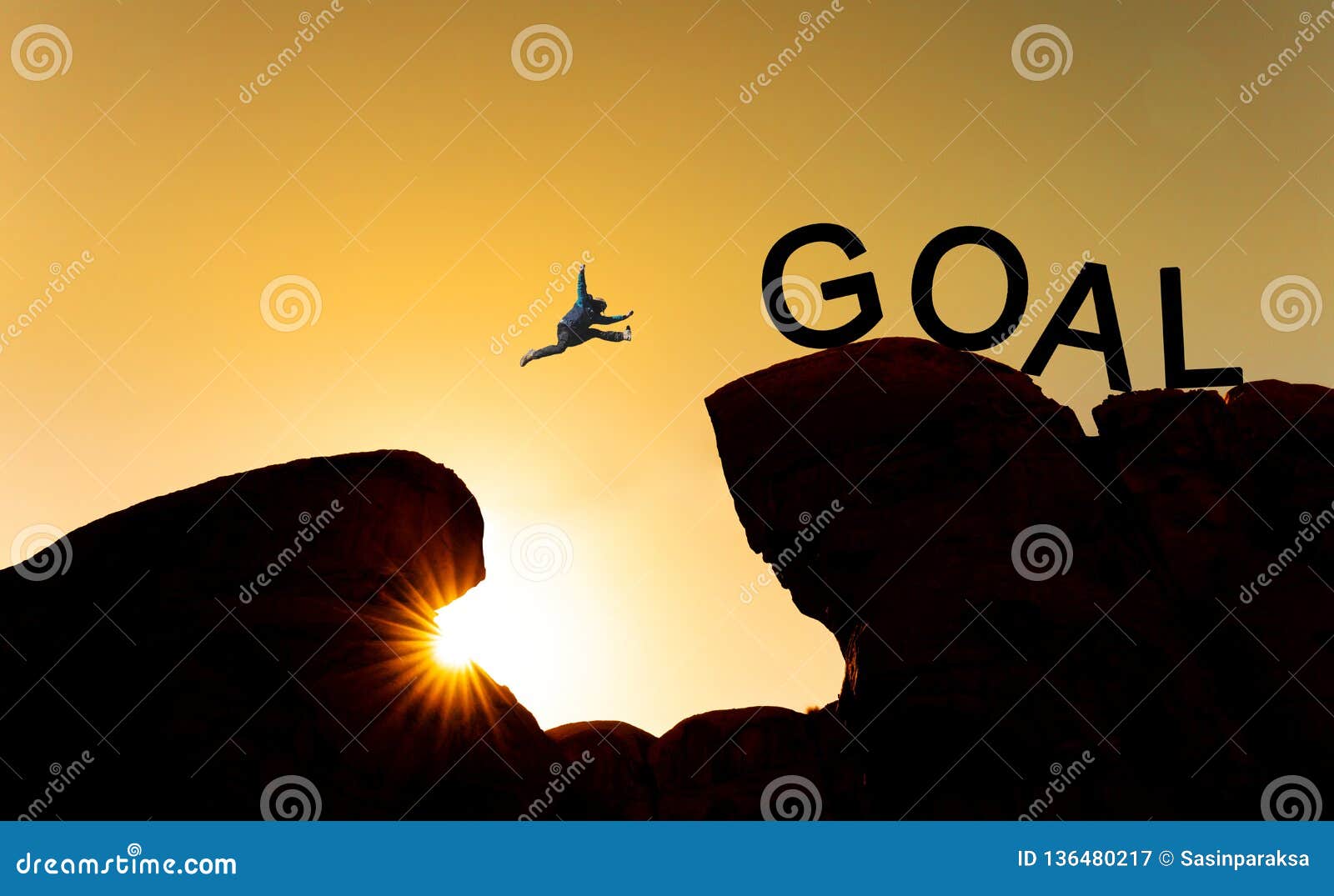 silhouette a man jumping over precipice to goal. achieve goal, business goals, challenge and success concept