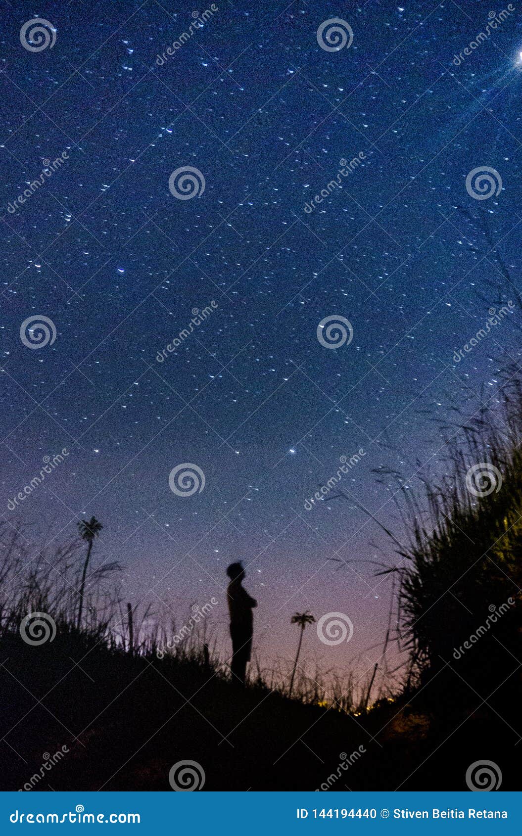 silhouette of  man looking at the infinity of stars