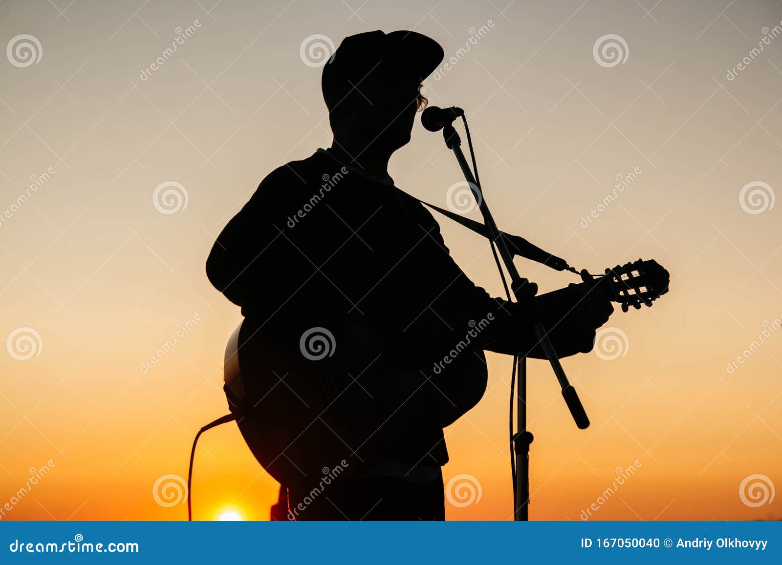 Download Silhouette Of A Man Playing Guitar And Singing Into A ...