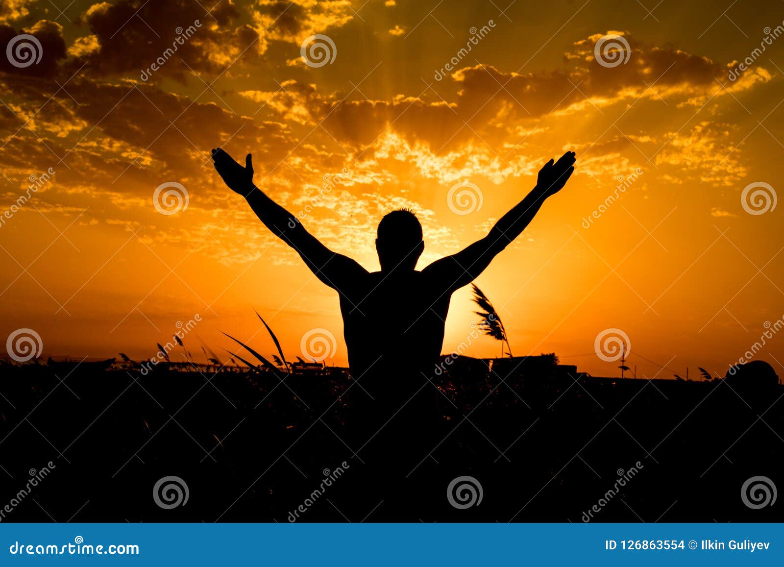 Silhouette of Man with Their Hands in the Sunset. Outdoor Shot Stock ...