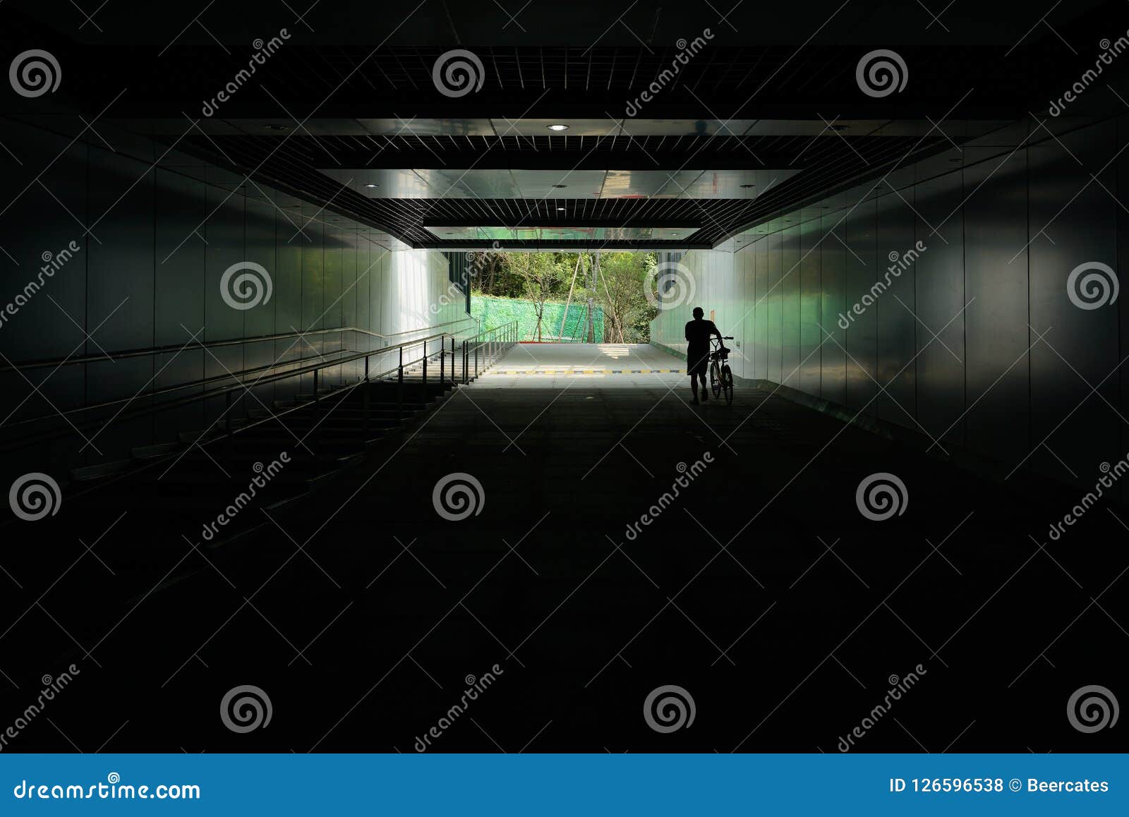 Silhouette Of Man Walking With Bike On Upslope In Road Tunnel Wi Stock ... Silhouette Man Walking Tunnel