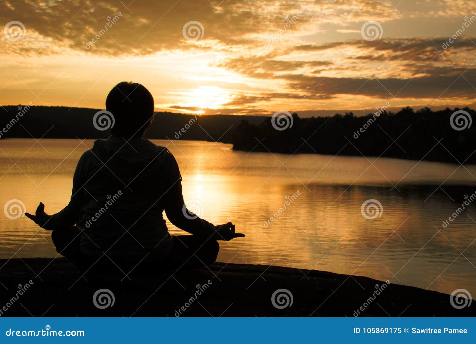 Meditation on sunset sky background. Young active woman in yoga