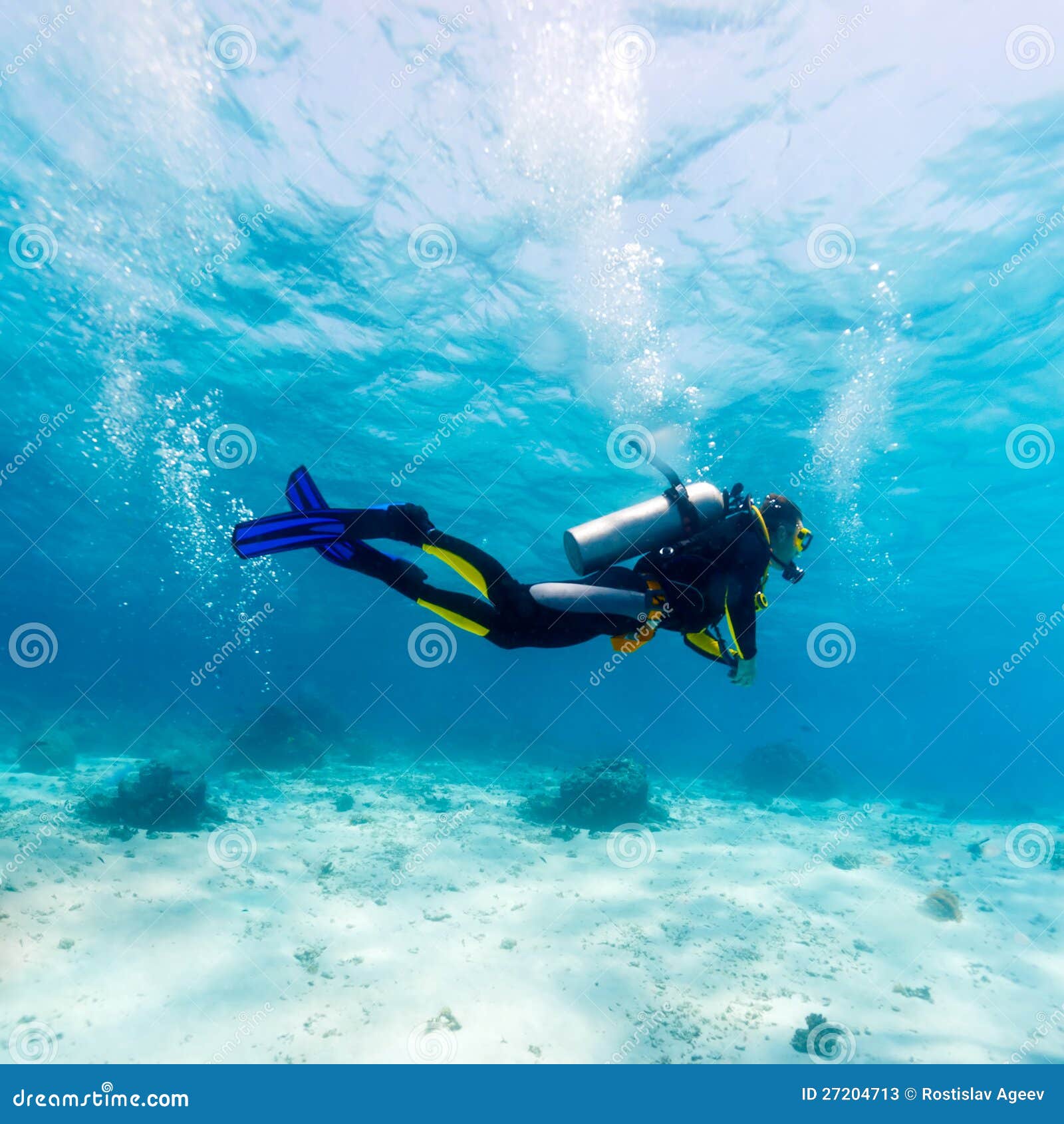 silhouette of scuba diver near sea bottom