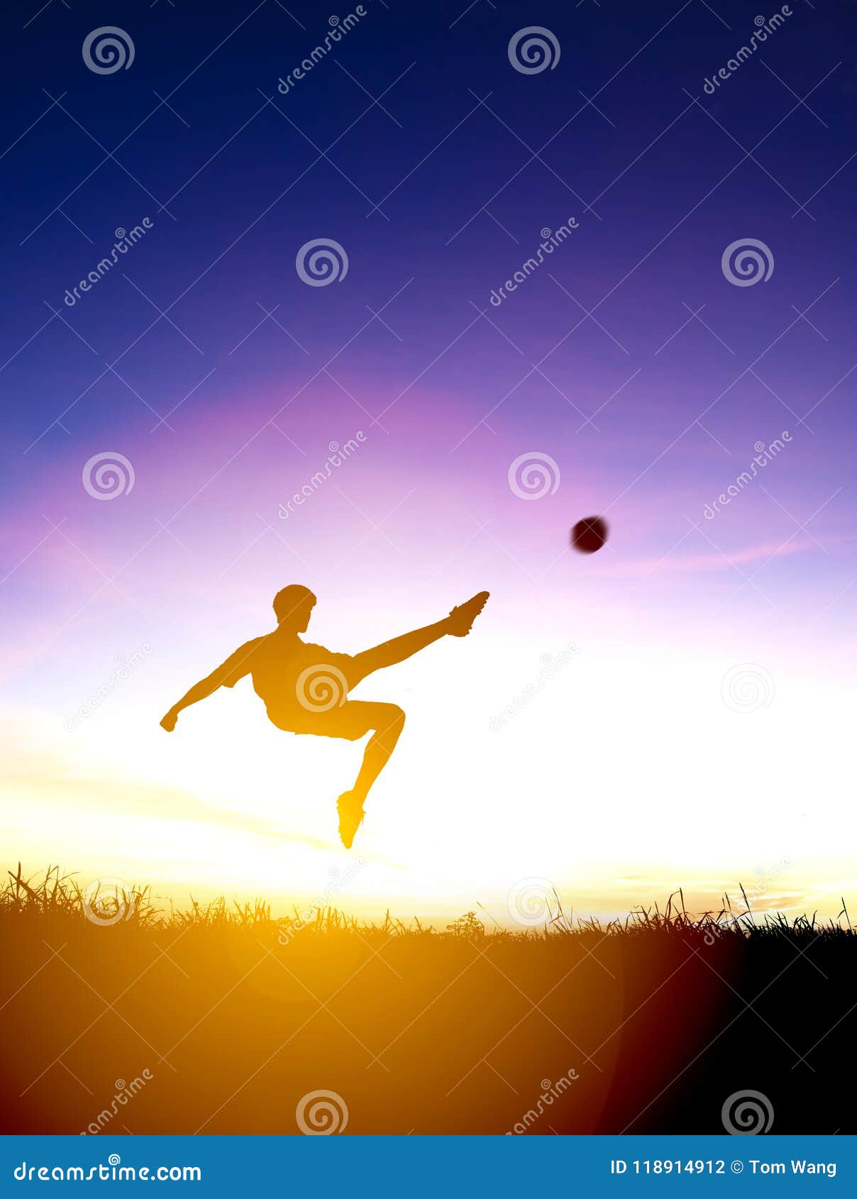 silhouette of soccer player kicks ball