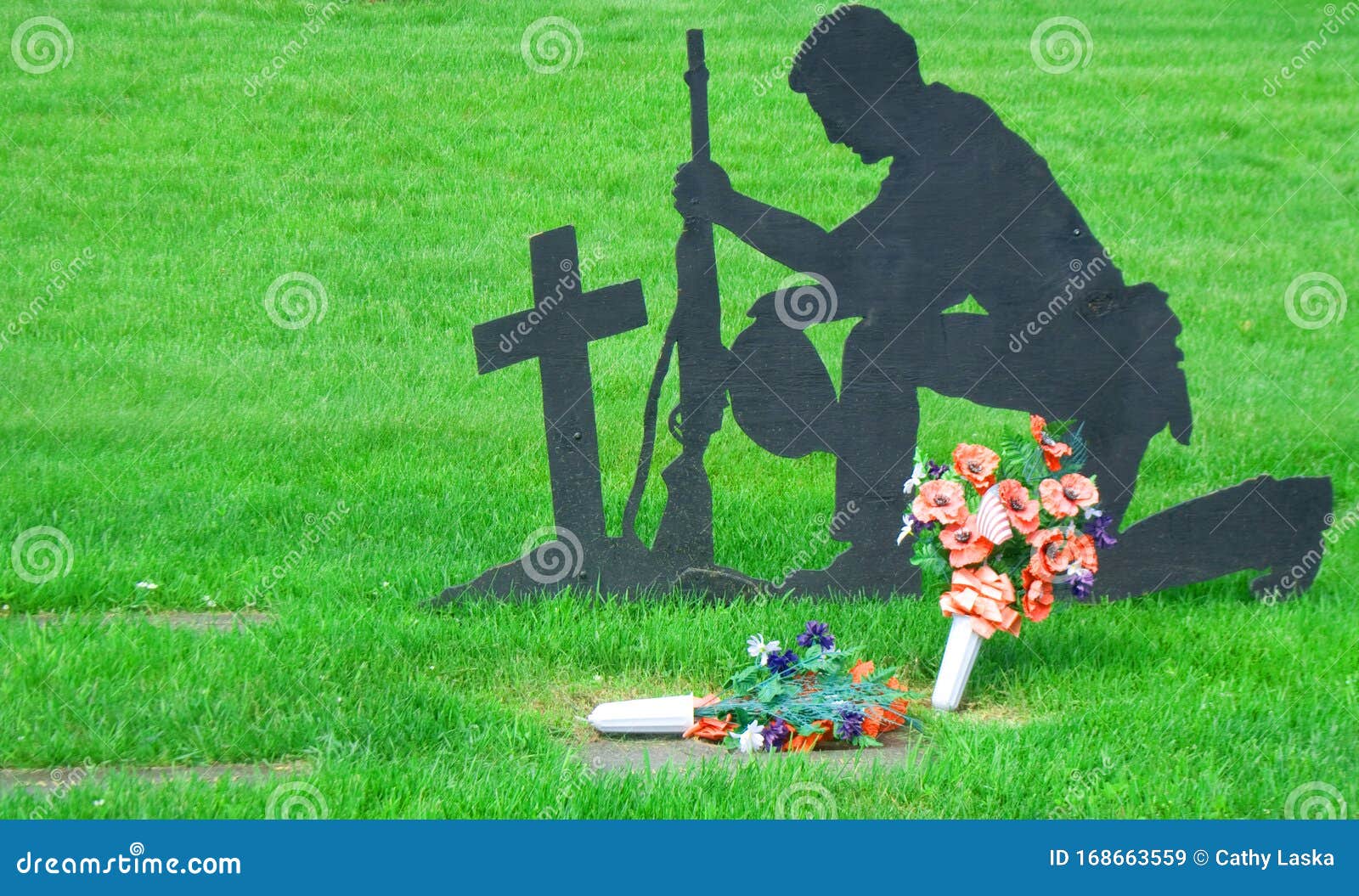 soldier kneeling at cross statue