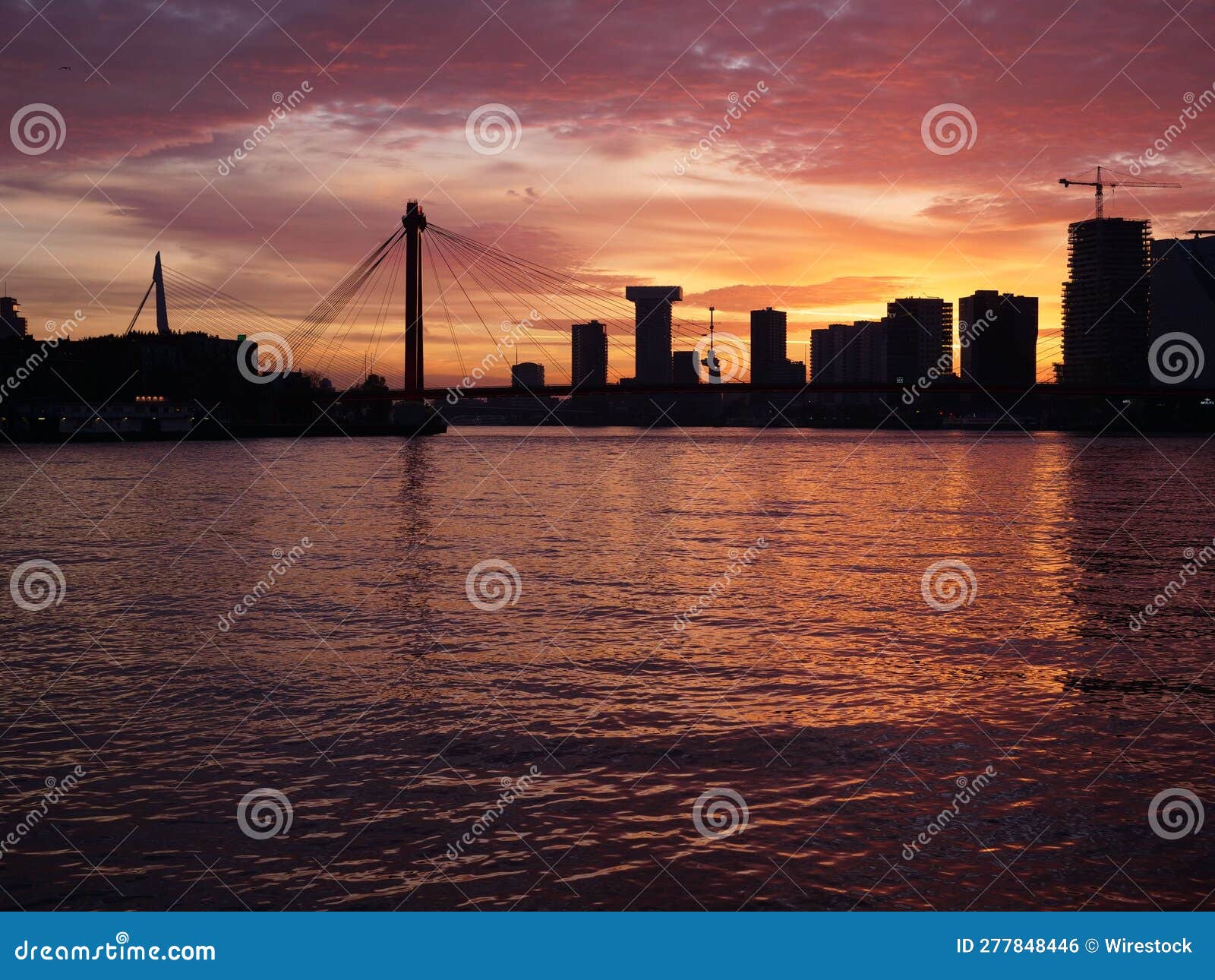 Silhouette of Stunning City Skyline Reflected in a River at Sunset ...