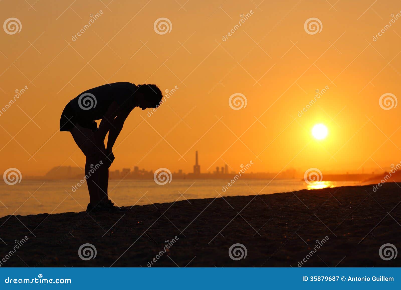 silhouette of an tired sportsman at sunset