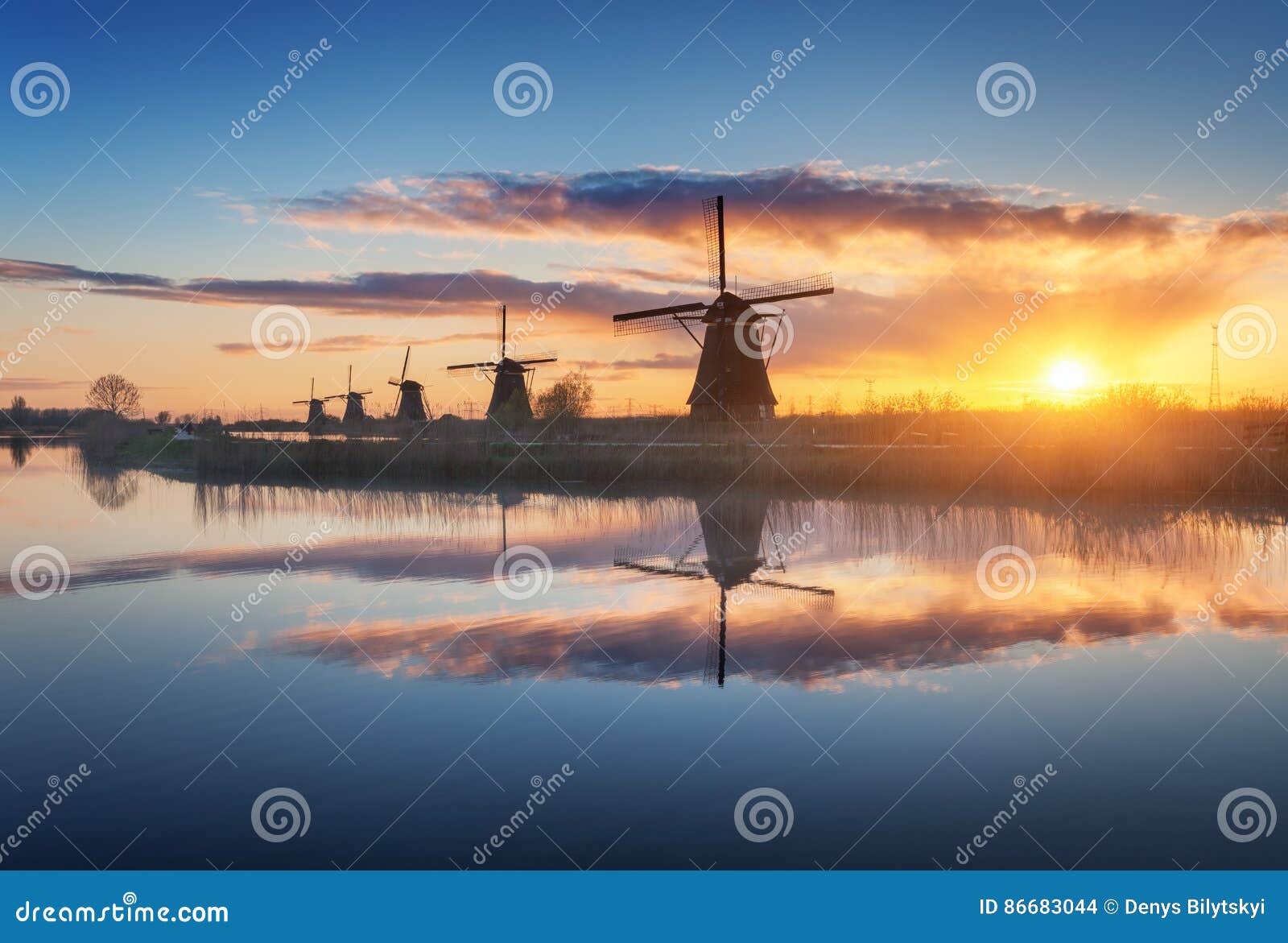 silhouette of windmills at sunrise in kinderdijk, netherlands