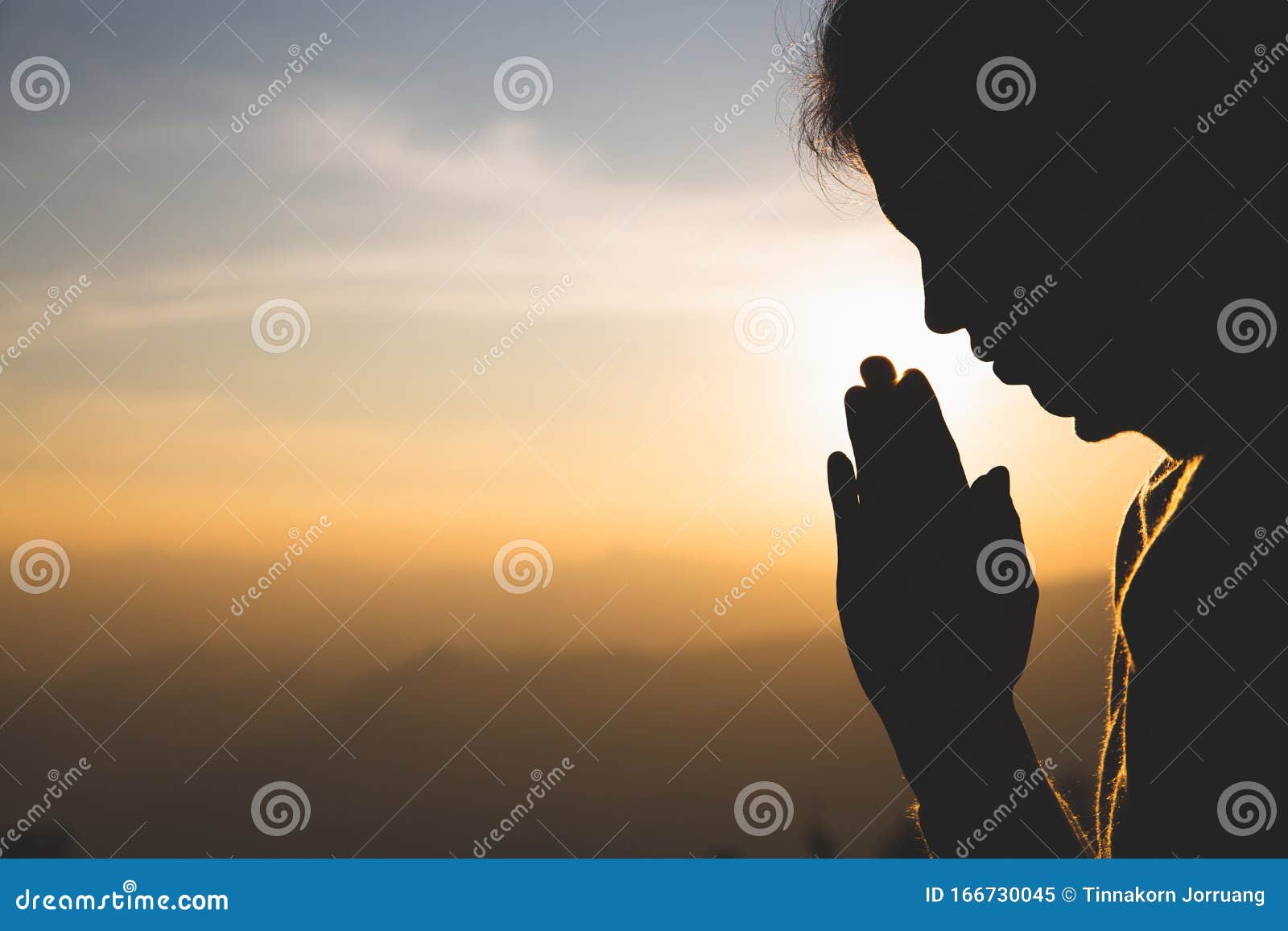 silhouette of a woman  praying hands with faith in religion and belief in god on the morning sunrise background.  namaste or