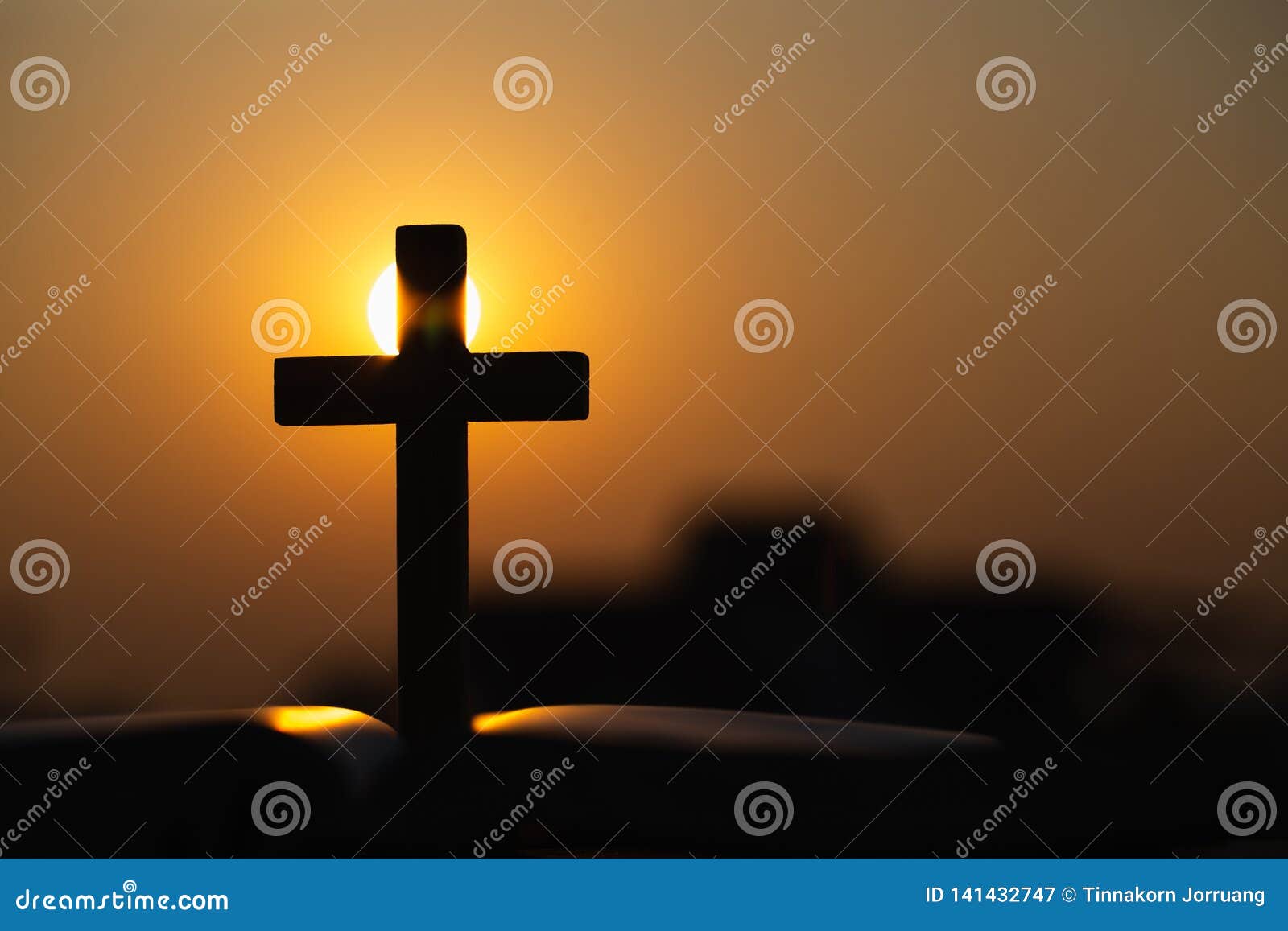 Silhouette of the Wooden Cross Over Opened Bible with a Bright ...