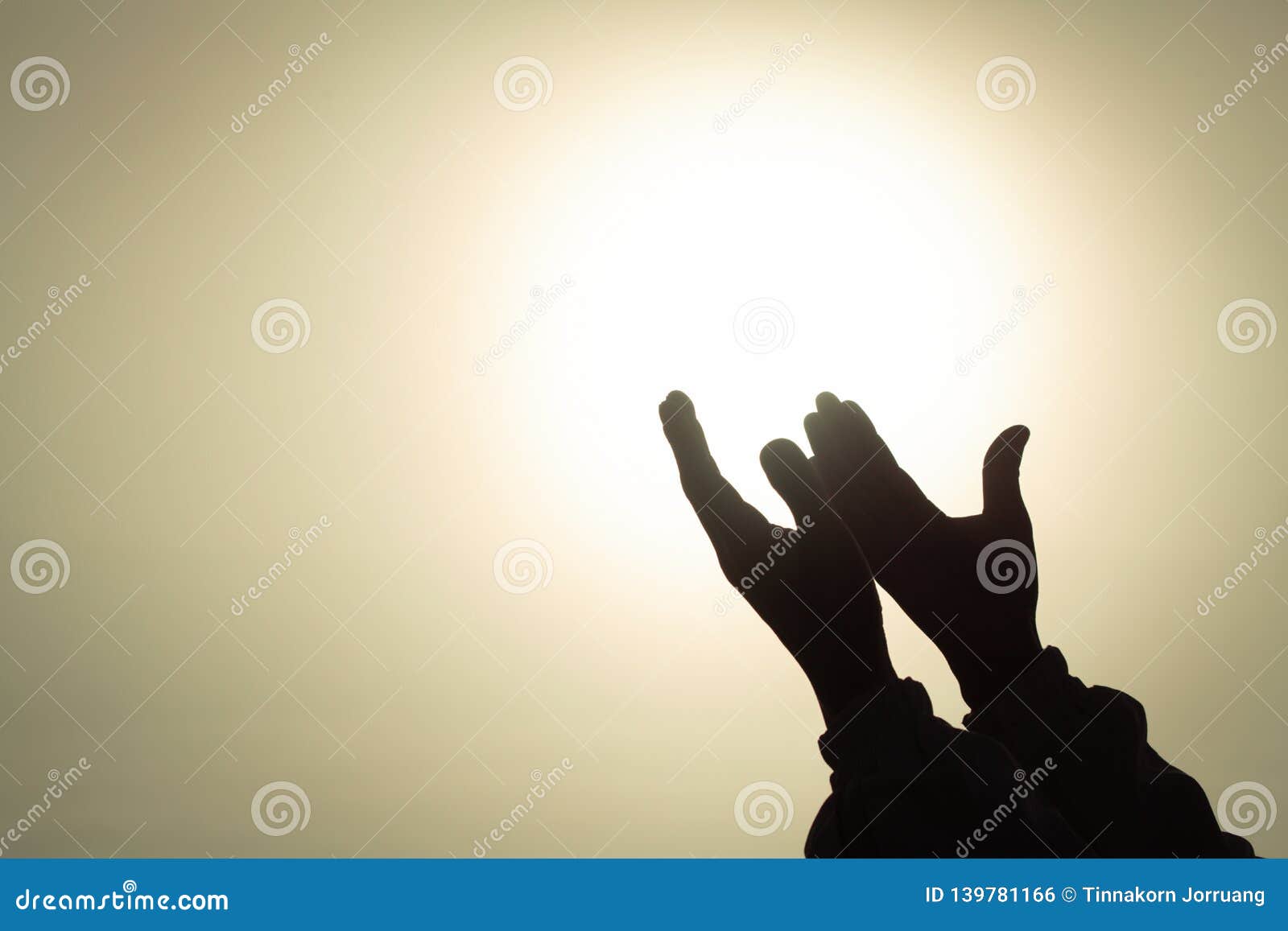 silhouette of young human hands open palm up worship and praying to god at sunrise, christian religion concept background