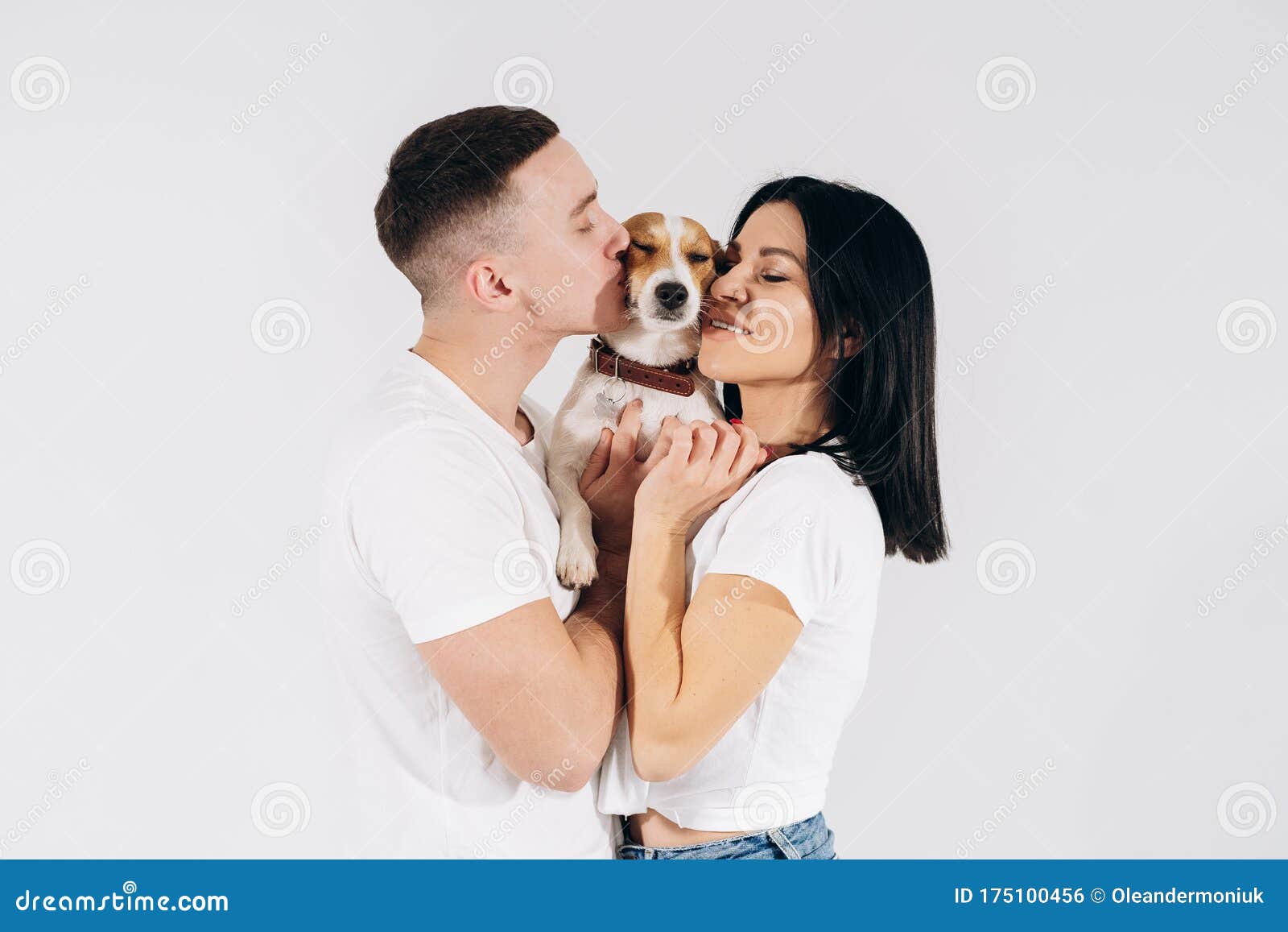 Young Man and Her Boyfriend with Their Dog at Studio. Young Owners Kissing  Pet. Young and Beautiful Couple Holding Dog Stock Photo - Image of funny,  cheerful: 175100456