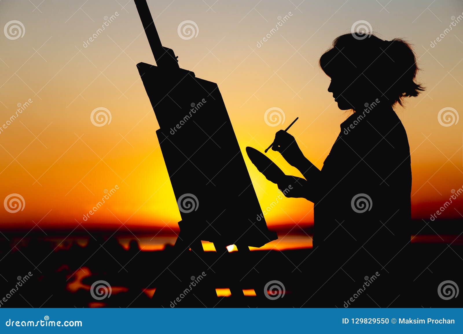 Silhouette of a Woman Painting a Picture on Linen on an Easel on the