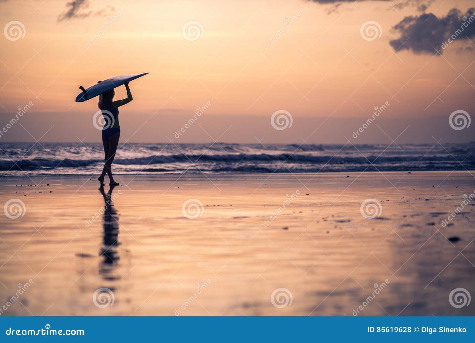 Silhouette Of Young Woman Walking Along The Beach At Sunset Stock Photo ...