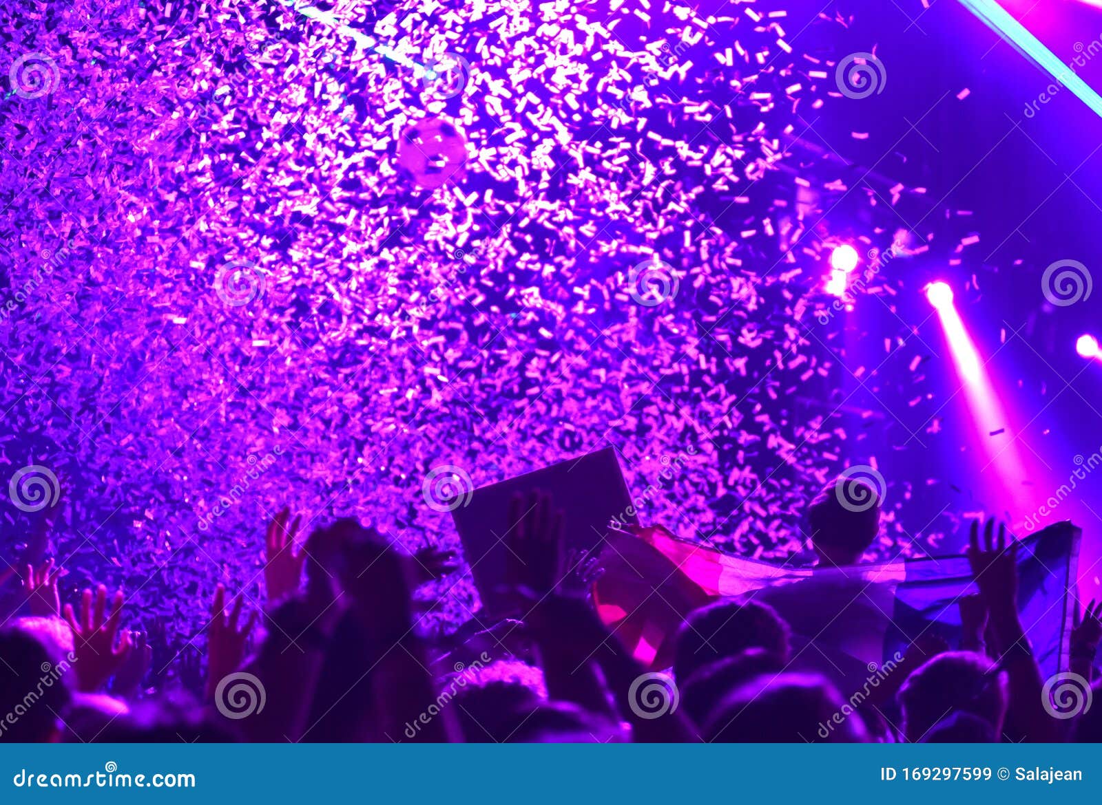 Concert Crowd in Front of Bright Stage Lights with Confetti Stock Image