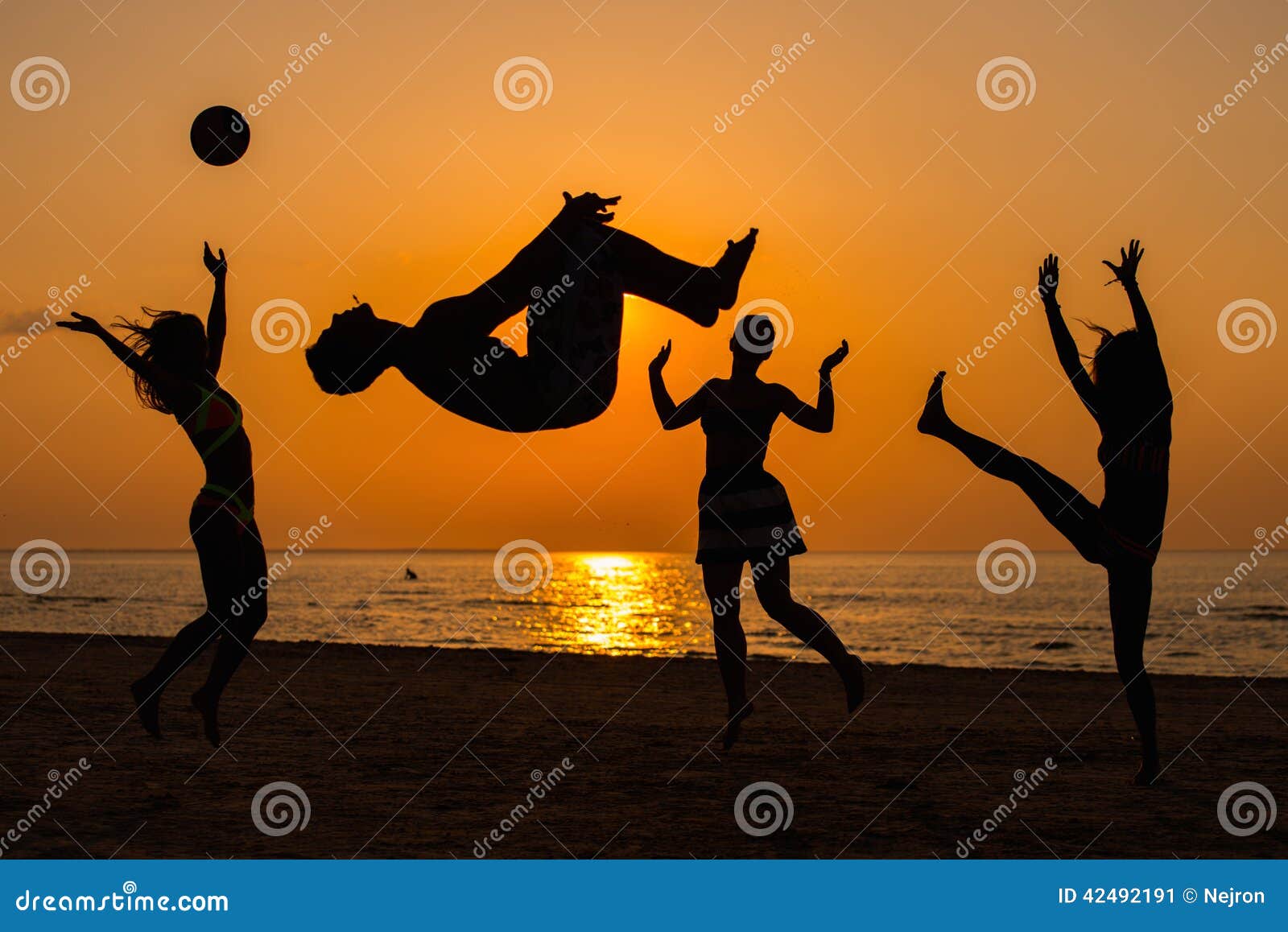 silhouettes of a people having fun on a beach