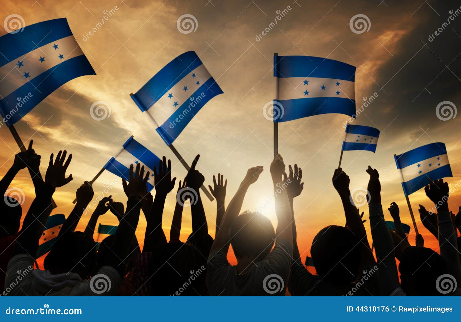 silhouettes of people holding flag of honduras