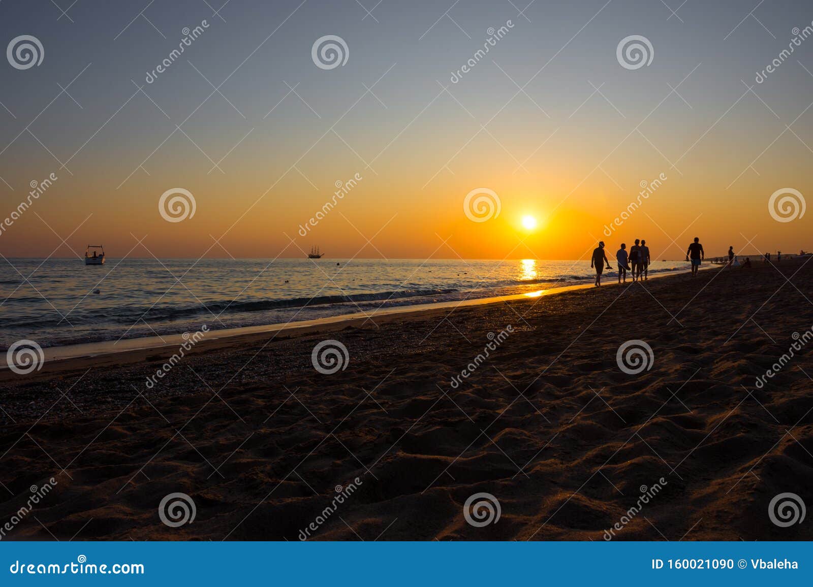 Silhouettes of People at Sunset on the Beach Stock Photo - Image of ...