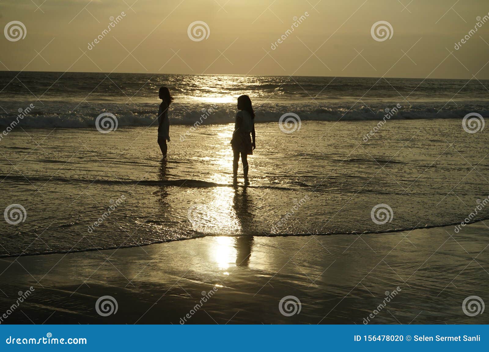 Silhouettes of Two Girls on the Beach at Sunset in Bali Editorial Image ...