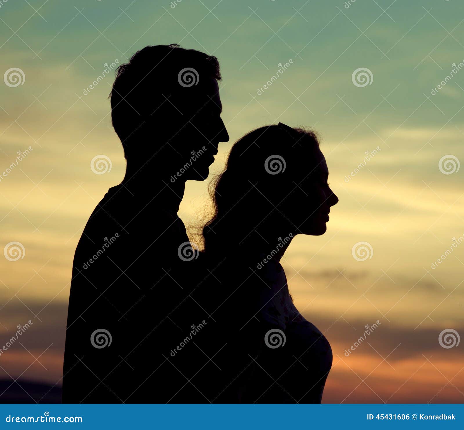 Running young couple in shadows with sun light behind them while wearing  black and grey jogging, Stock Photo, Picture And Royalty Free Image.  Pic. WE144805