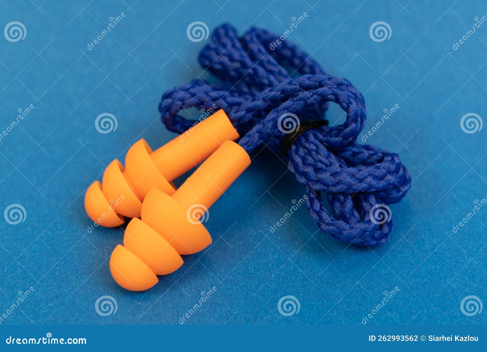 Silicone Ear Plugs for Human Ears on Blue Background Stock Photo