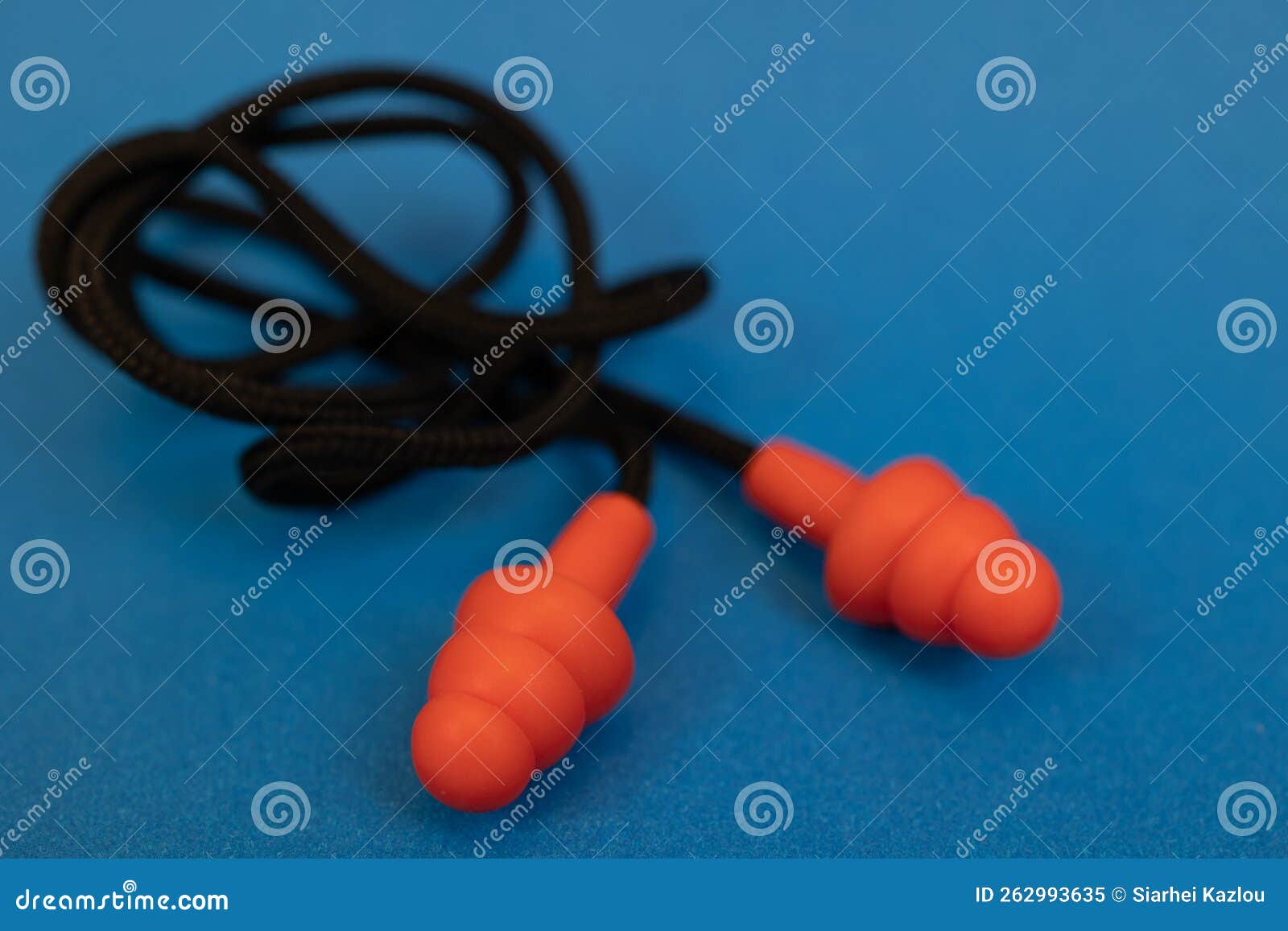 Silicone Ear Plugs for Human Ears on Blue Background Stock Image