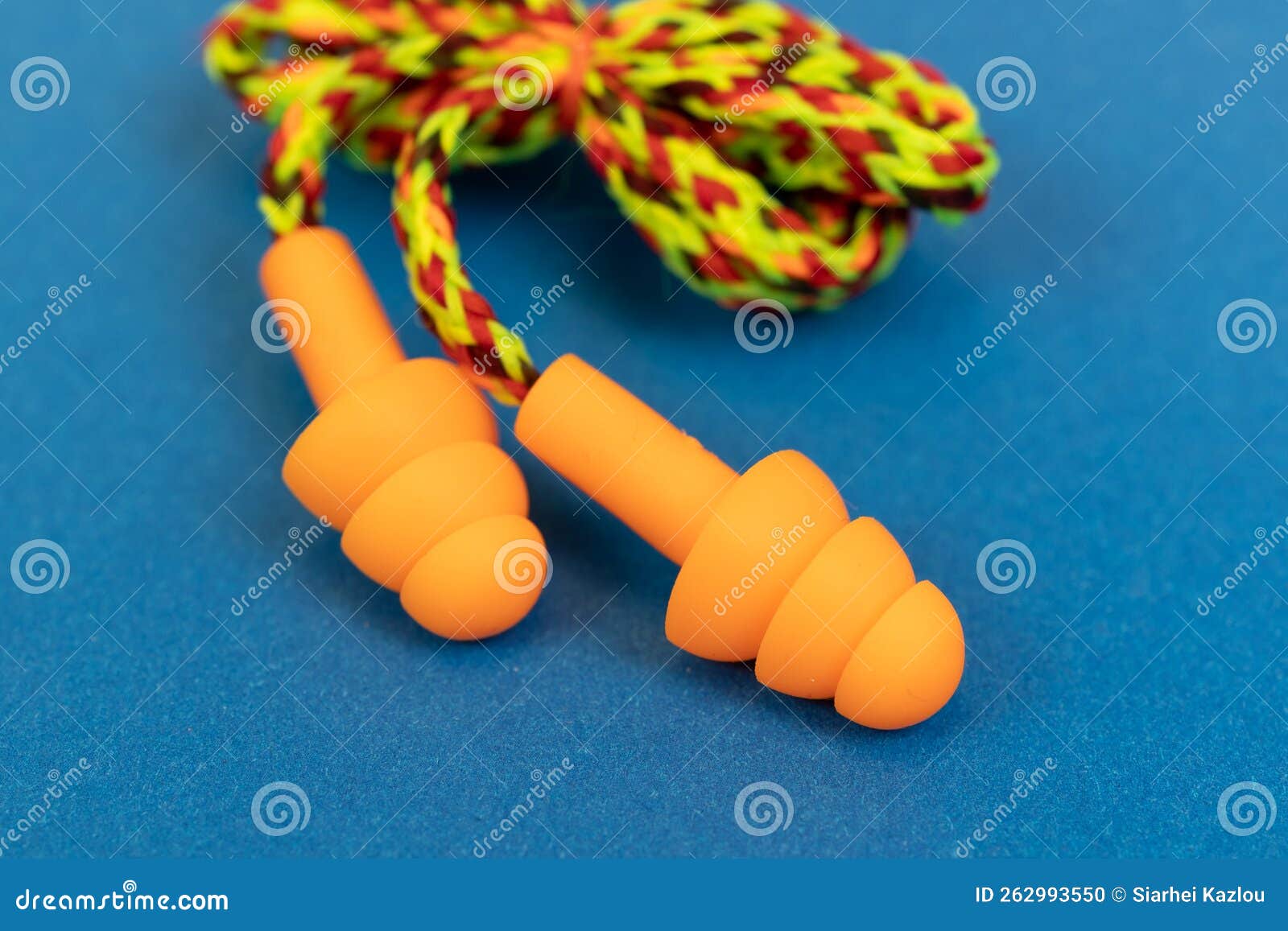 Silicone Ear Plugs for Human Ears on Blue Background Stock Photo