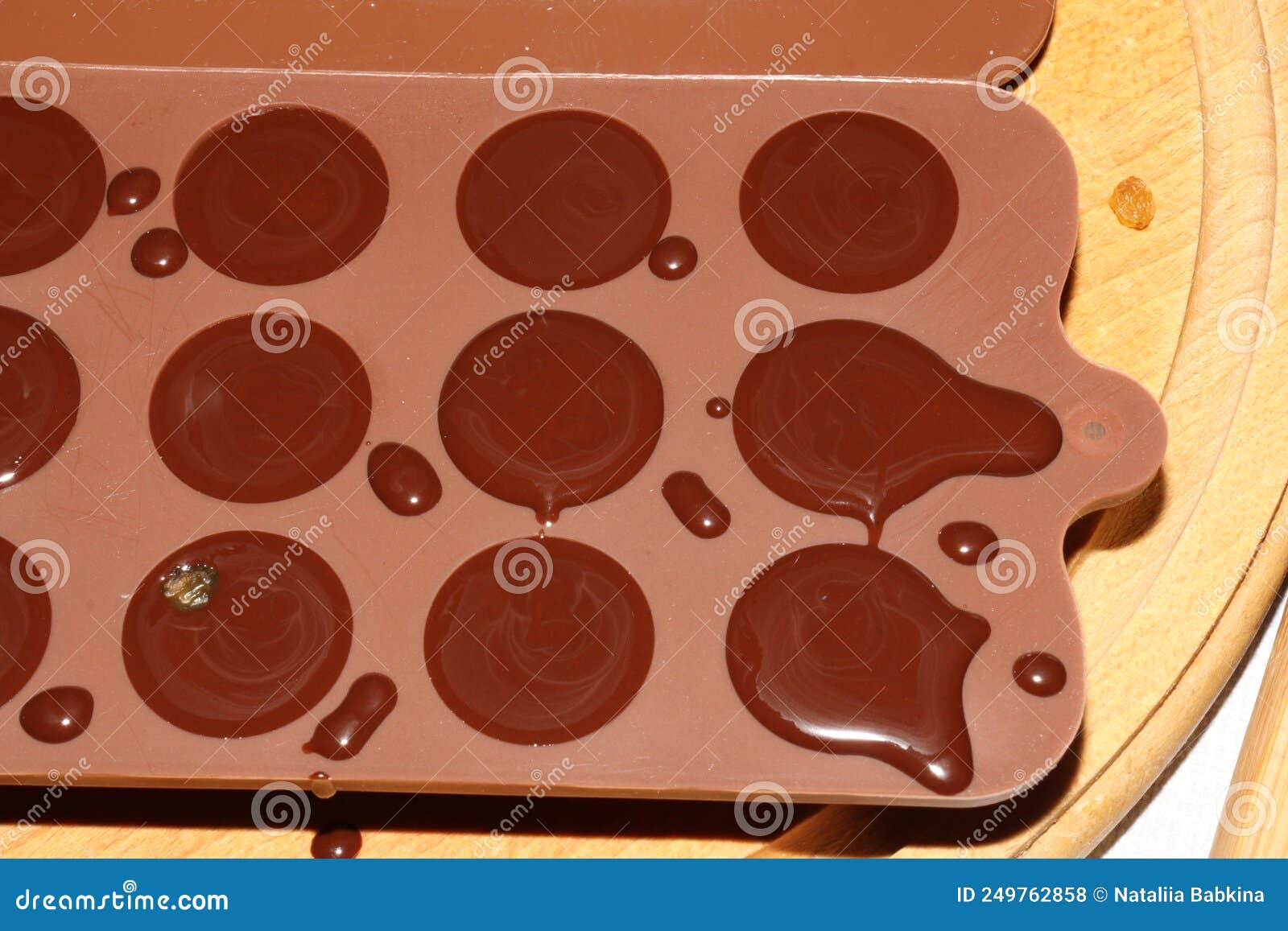 silicone molds for shaping chocolate and sweets are filled with hot chocolate to cool