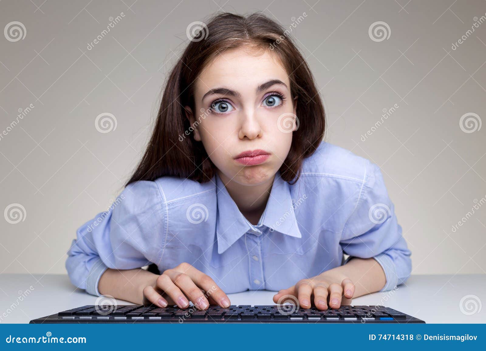 silly young woman using keyboard