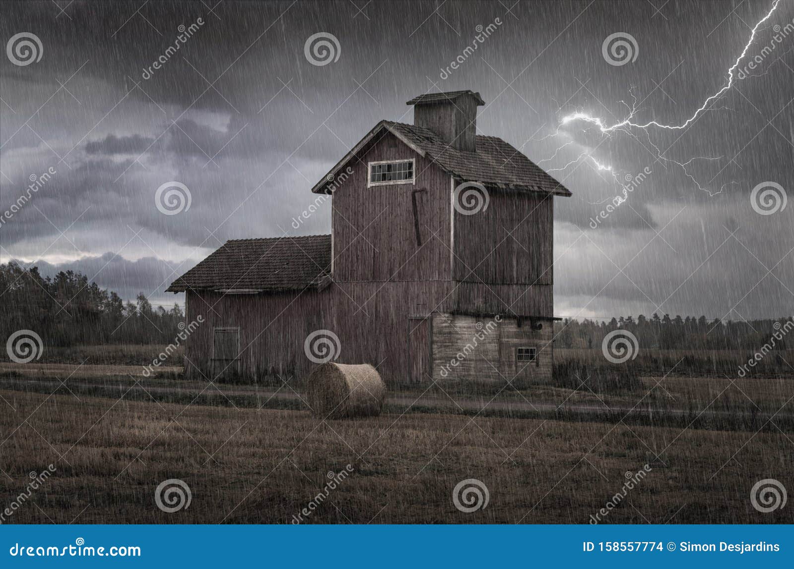 Silo Barn in the Rain with Lightning in the Sky and Dark Clouds in a Field  with a Bale of Hay Stock Photo - Image of forsaken, humid: 158557774
