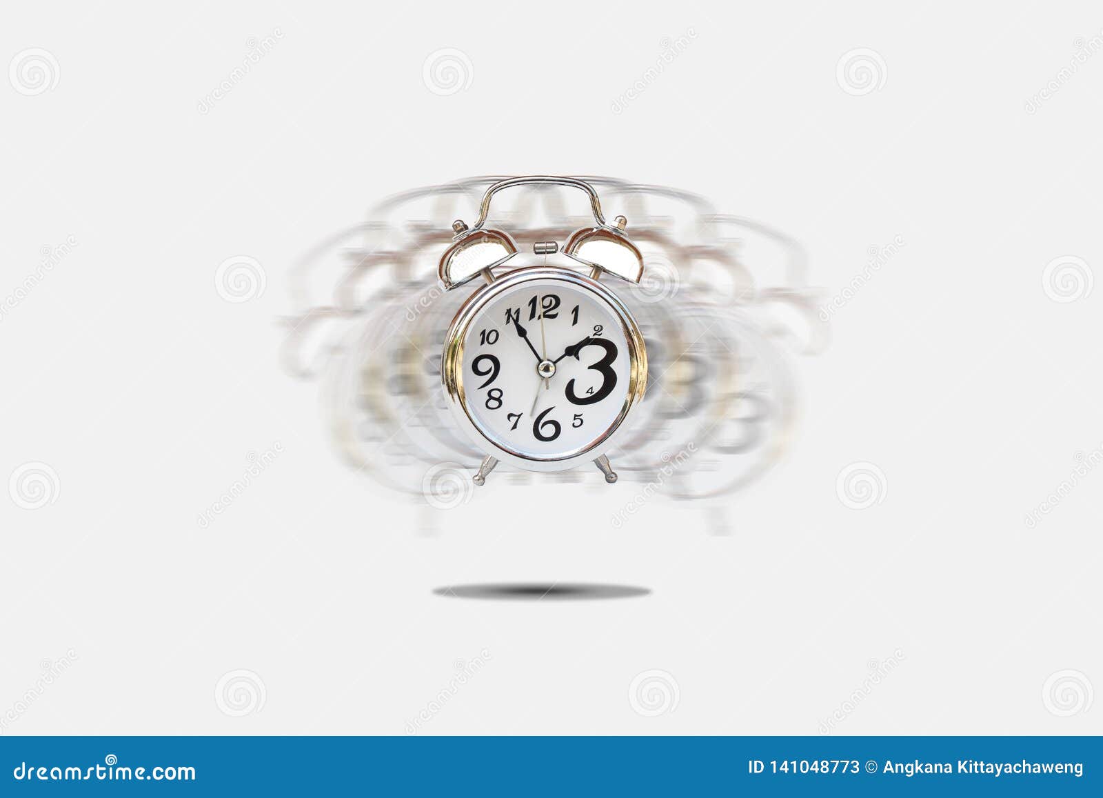 silver alarm clock alerting on gray background.