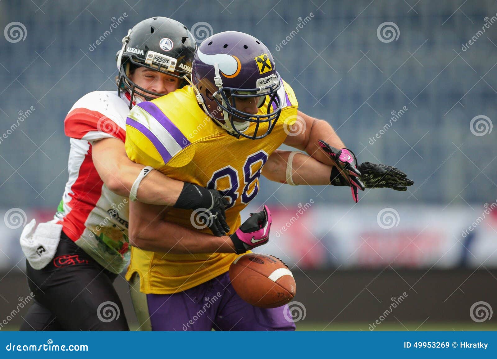 ST. POELTEN, AUSTRIA - JULY 26, 2014: DB Nikolaus Rabitsch (#17 Lions) strips the ball from WR Sam Hassanein (#88 Vikings) during Silver Bowl XVII.