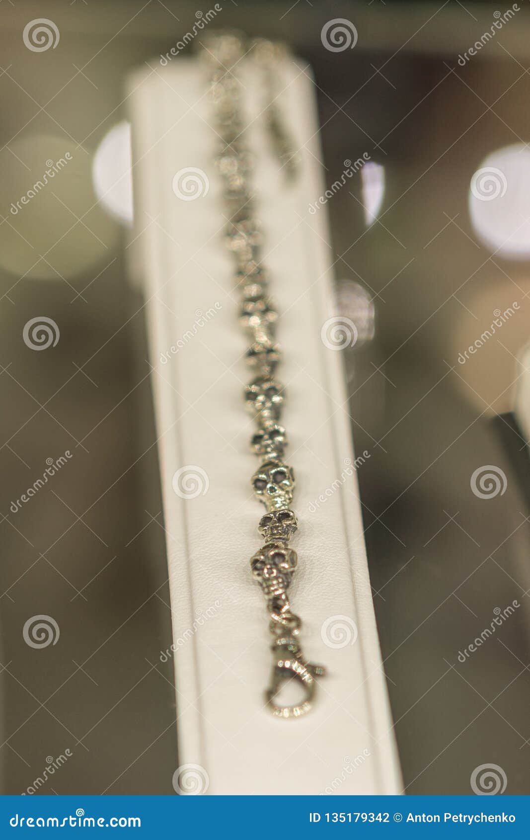 silver bracelet with skulls on the wind. selected focus. vertical photo
