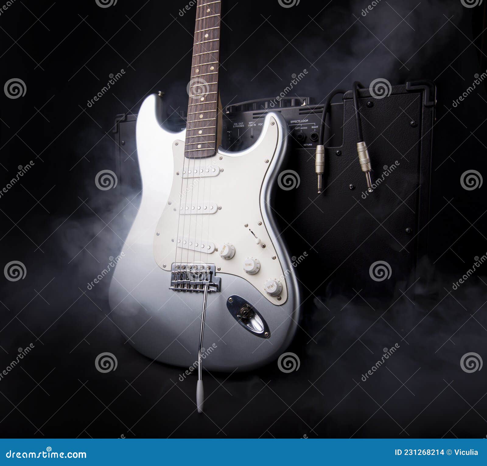 Silver Electric Guitar and Guitar Amplifier in Smoke on Black