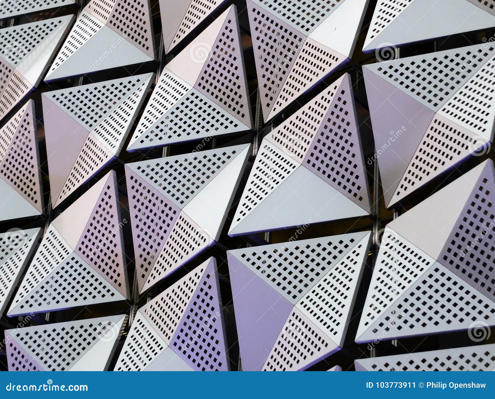 Silver Geometric Steel Cladding with Angular Patterns Stock Image