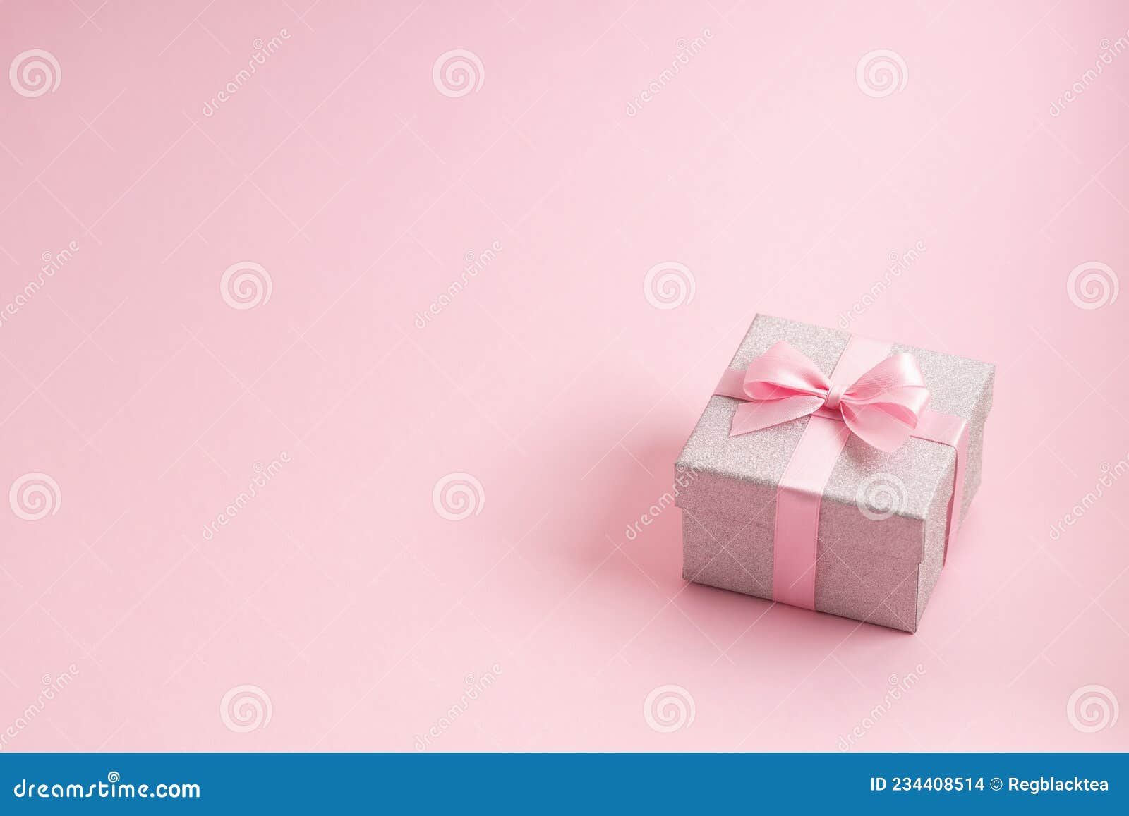 Premium Photo  Small gift box with bow pink and silver ribbon for gift  wrapping on pink background