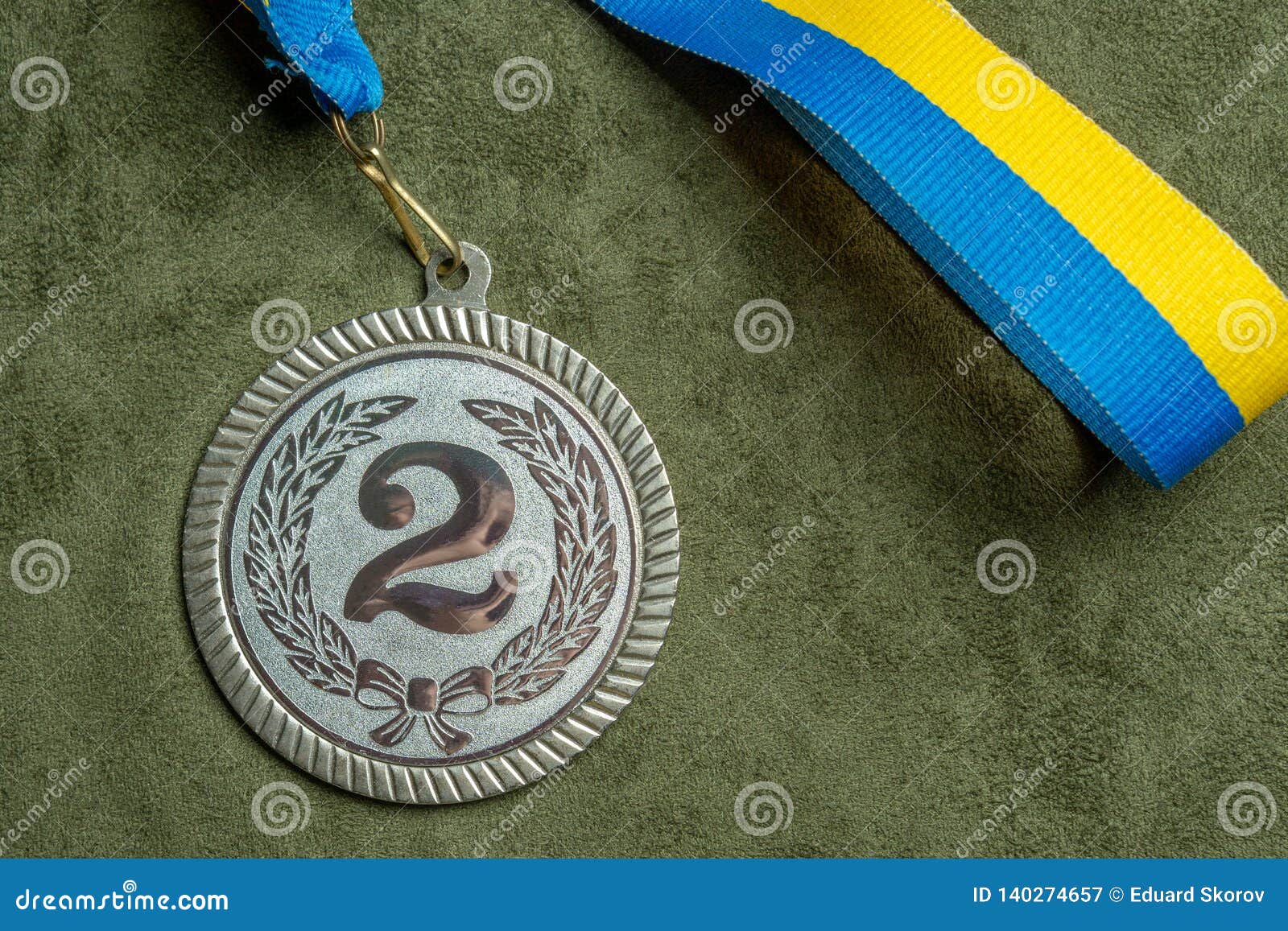 Silver Medal with a Yellow and Blue Ribbon. Closeup Stock Image