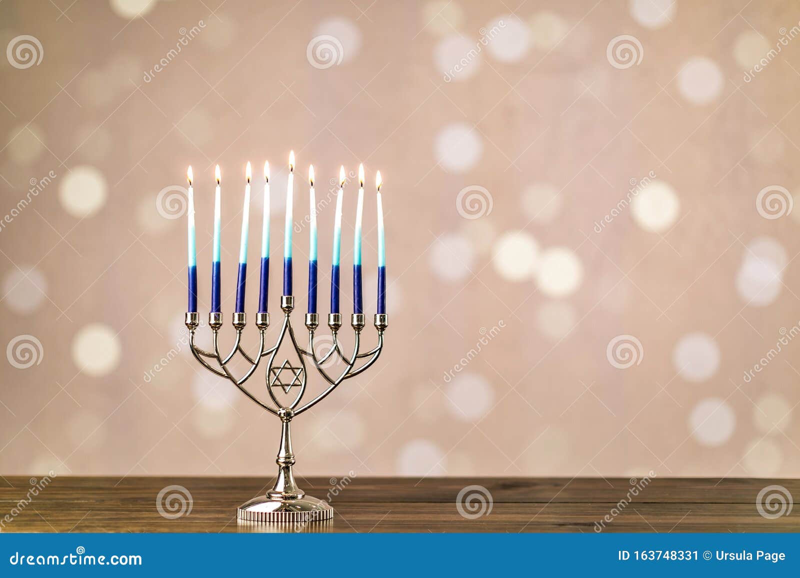 a silver menorah for the jewish holiday hanukkah with eight unlit candles