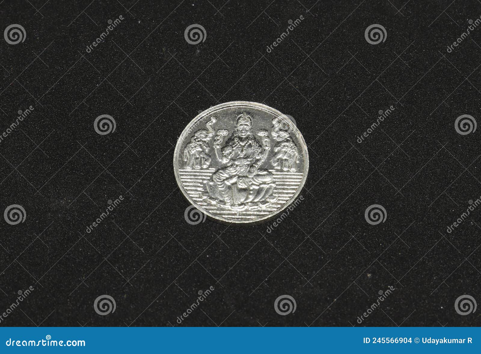 silver metal lakshmi coin.