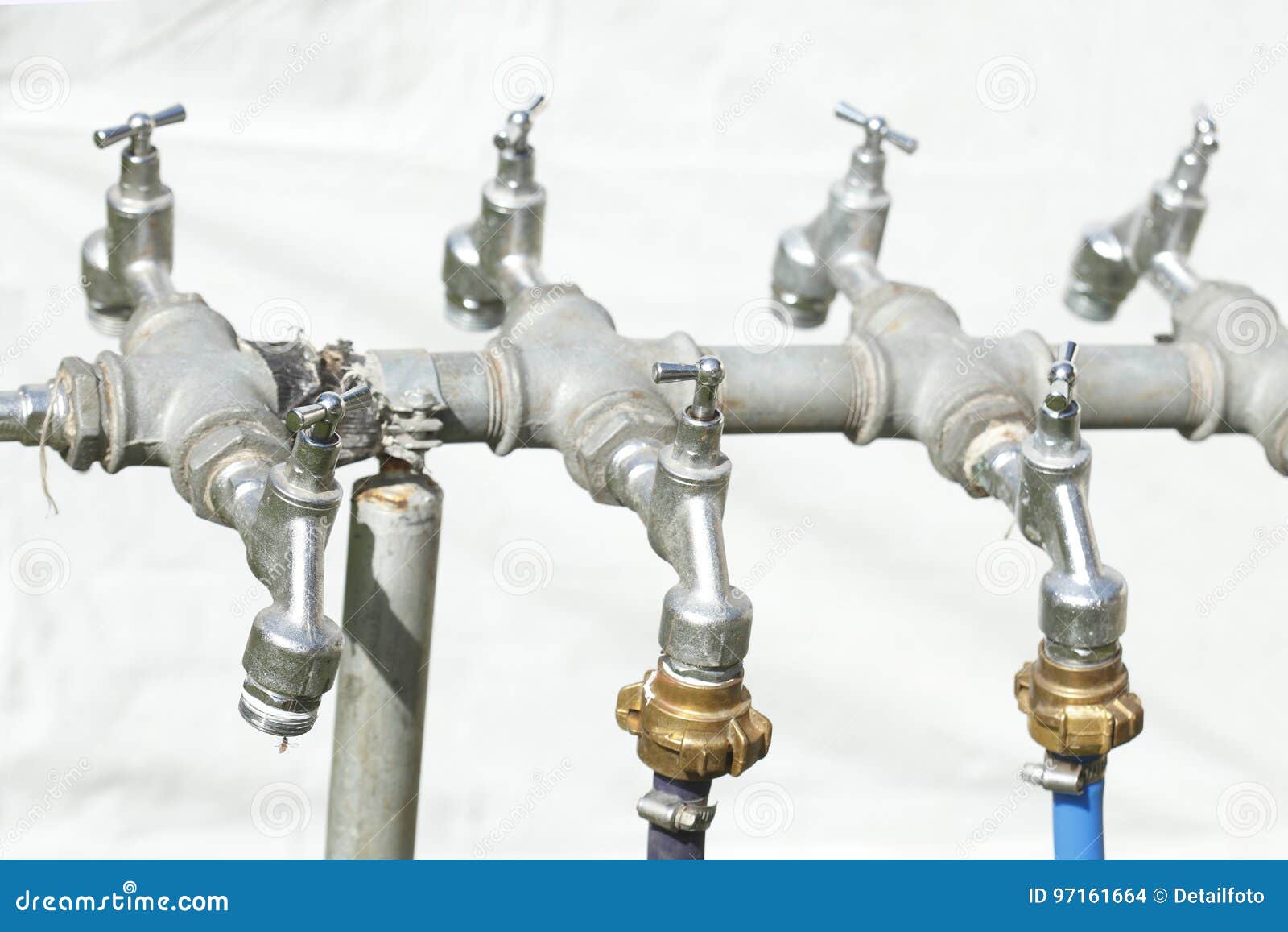 silver-metal-outside-water-taps-multiple